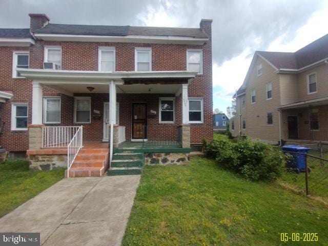 608 Chestnut Hill Ave, Baltimore, MD 21218 - multi unit property featuring brick siding, a front lawn, and a porch