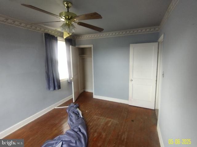 608 Chestnut Hill Ave, Baltimore, MD 21218 - unfurnished bedroom featuring wood finished floors, baseboards, a closet, and a ceiling fan