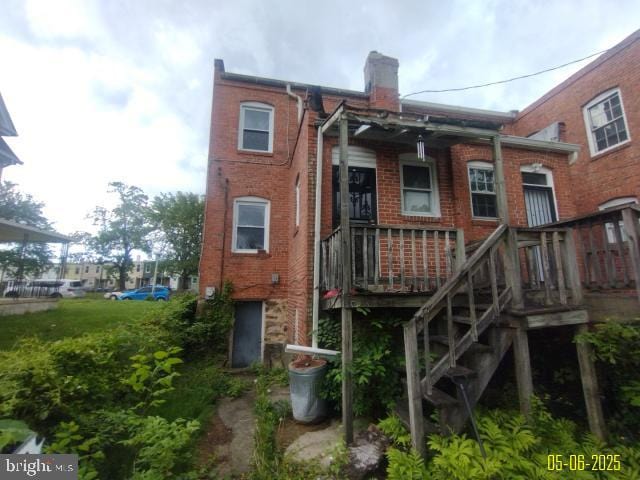 608 Chestnut Hill Ave, Baltimore, MD 21218 - back of house featuring brick siding, a chimney, and a deck