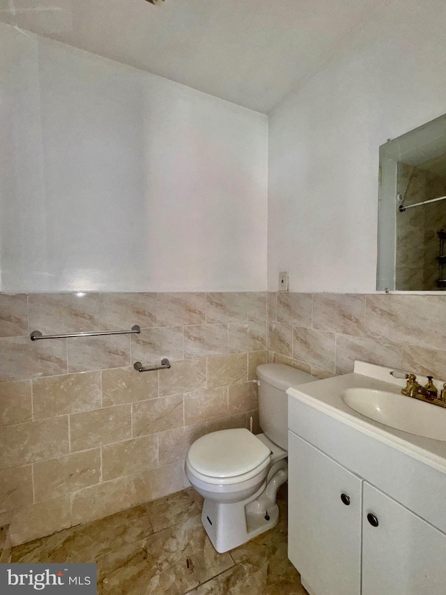 240 W Glenwood Ave, Philadelphia, PA 19140 - full bath featuring vanity, toilet, tile walls, a shower, and wainscoting