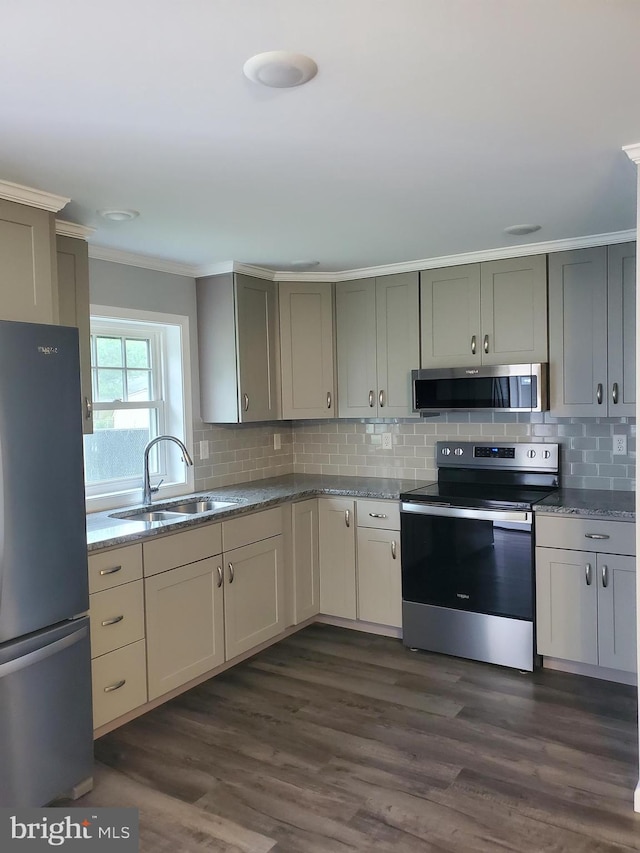 113 Beech Tree Ln, Harrington, DE 19952 - kitchen featuring stainless steel appliances, a sink, ornamental molding, backsplash, and light stone counters
