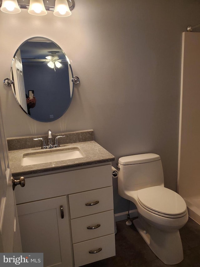 113 Beech Tree Ln, Harrington, DE 19952 - bathroom with vanity, toilet, a ceiling fan, and baseboards