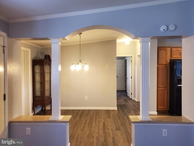 113 Beech Tree Ln, Harrington, DE 19952 - unfurnished dining area with decorative columns, dark wood finished floors, arched walkways, baseboards, and ornamental molding