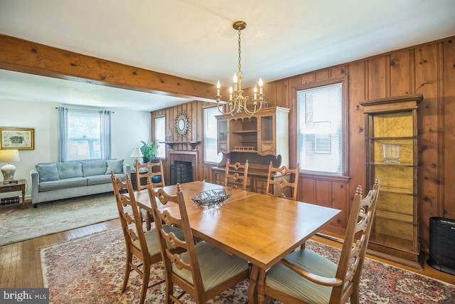 742 Arndt Ave, Riverside, NJ 08075 - dining room featuring hardwood / wood-style flooring, a chandelier, healthy amount of natural light, beamed ceiling, and wooden walls
