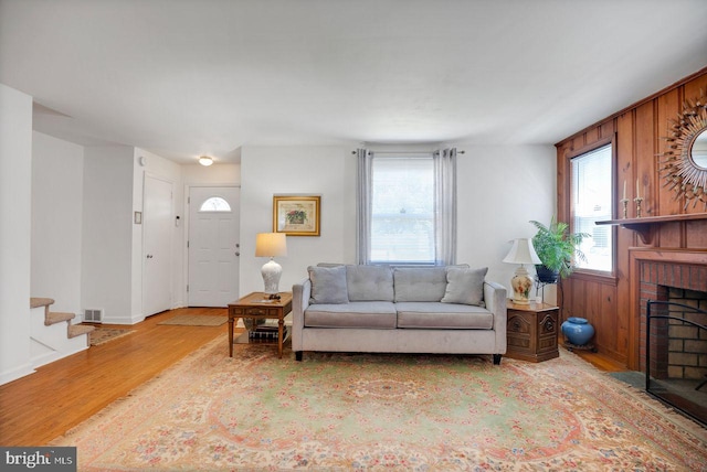 742 Arndt Ave, Riverside, NJ 08075 - living room with wood finished floors, a brick fireplace, stairs, and baseboards