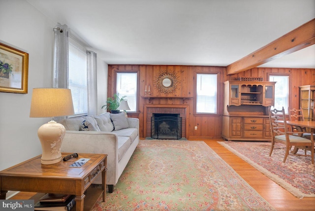 742 Arndt Ave, Riverside, NJ 08075 - living room featuring plenty of natural light, wooden walls, wood finished floors, a fireplace, and beamed ceiling