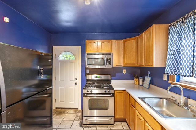 133 W Norris St, Philadelphia, PA 19122 - kitchen with appliances with stainless steel finishes, a sink, light countertops, and light tile patterned floors