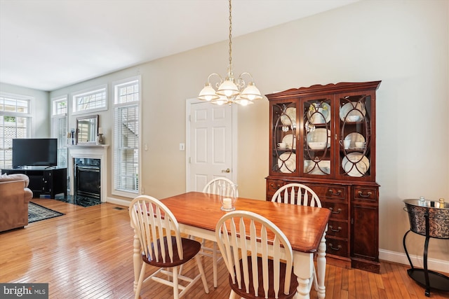 713 Bright Meadow Dr, Gaithersburg, MD 20878 - dining area featuring hardwood / wood-style flooring, a premium fireplace, and a chandelier