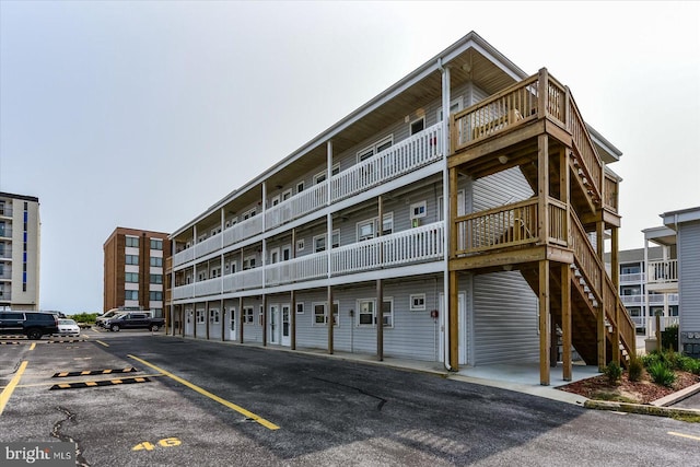 12 72nd St Unit 303, Ocean City, MD 21842 - view of property featuring uncovered parking and stairs