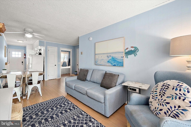 12 72nd St Unit 303, Ocean City, MD 21842 - living area with wood finished floors, ceiling fan, and a textured ceiling