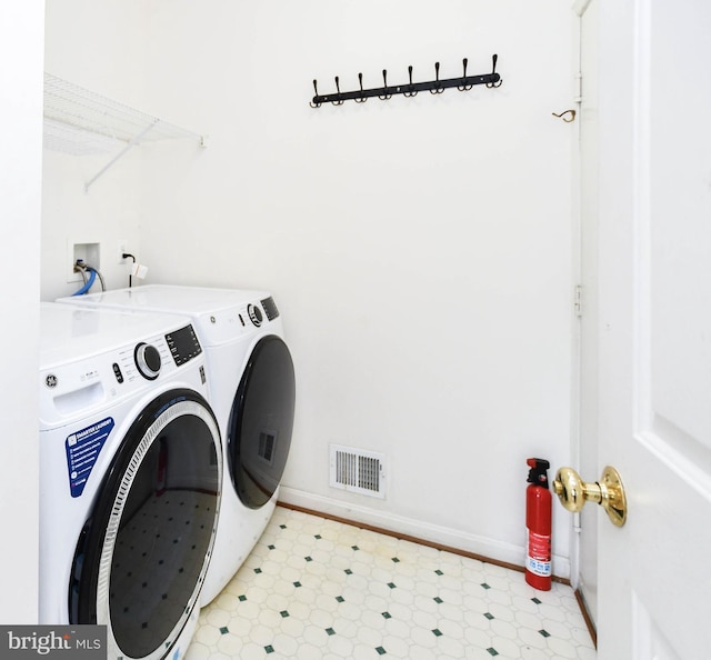 11212 Snowden Pond Rd, Laurel, MD 20708 - laundry area with washer and clothes dryer, light flooring, and baseboards