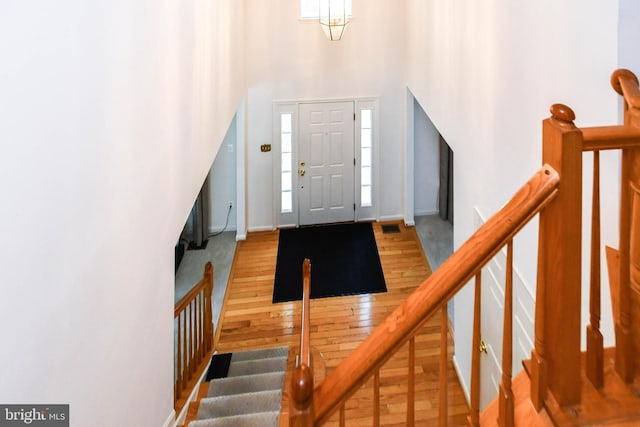 11212 Snowden Pond Rd, Laurel, MD 20708 - foyer entrance featuring hardwood / wood-style floors, a towering ceiling, and baseboards