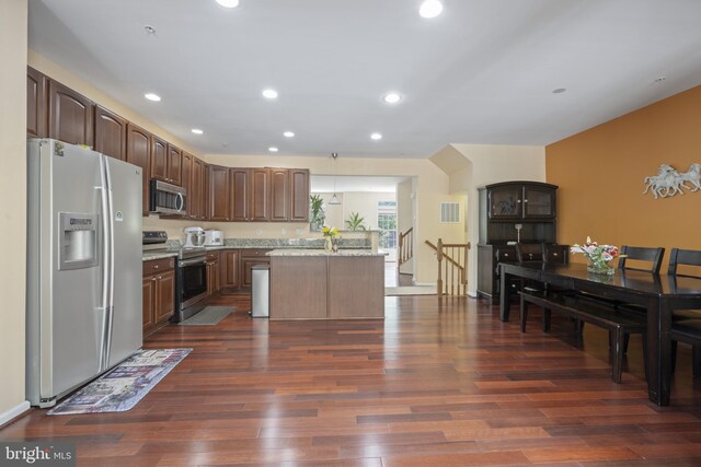 10745 Hillingdon Rd, Woodstock, MD 21163 - kitchen with appliances with stainless steel finishes, dark wood finished floors, recessed lighting, light stone countertops, and dark brown cabinets