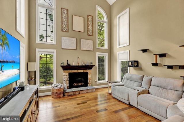12 Fox Glen Dr, Reading, PA 19608 - living area featuring light wood-style floors, a towering ceiling, a fireplace, and plenty of natural light