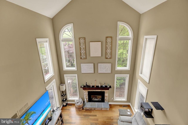 12 Fox Glen Dr, Reading, PA 19608 - living room with high vaulted ceiling, wood finished floors, a stone fireplace, and baseboards