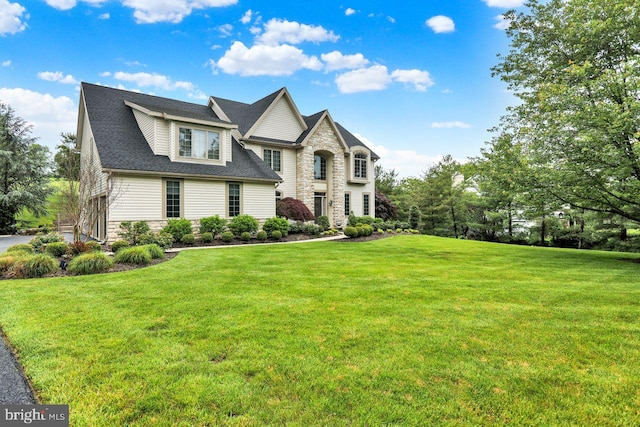 12 Fox Glen Dr, Reading, PA 19608 - french country style house with stone siding, a front yard, and roof with shingles