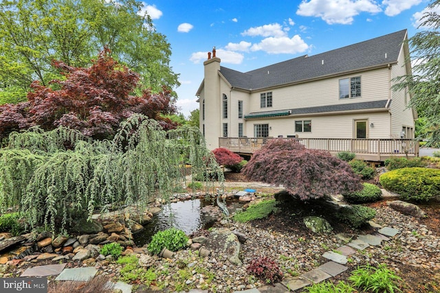 12 Fox Glen Dr, Reading, PA 19608 - back of property featuring a deck, a chimney, and a garden pond