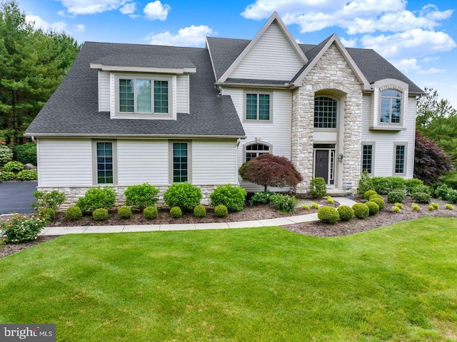 12 Fox Glen Dr, Reading, PA 19608 - view of front of property featuring stone siding, a front yard, and roof with shingles