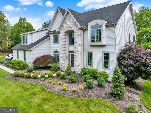 12 Fox Glen Dr, Reading, PA 19608 - french country style house with stone siding, a front yard, and roof with shingles
