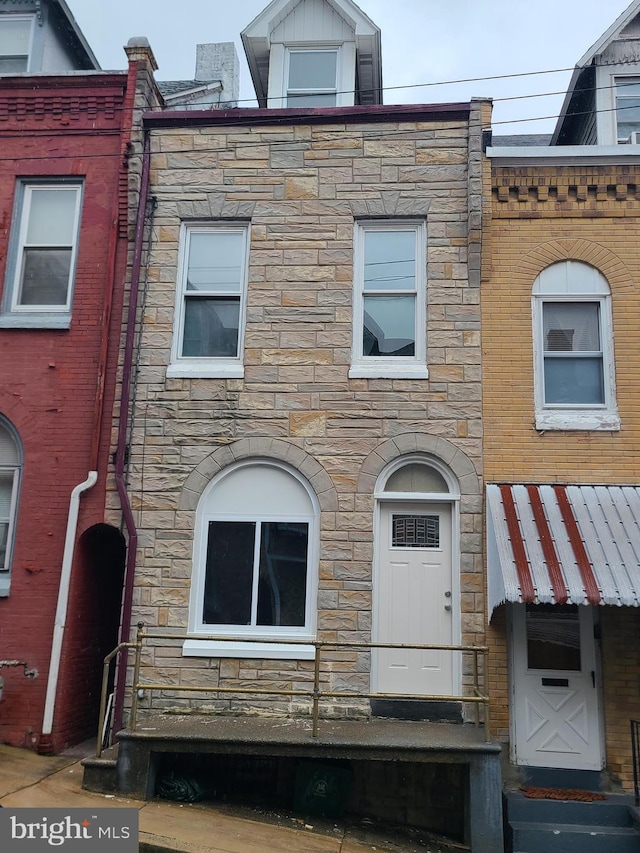 1218 Fidelity St, Reading, PA 19604 - townhome / multi-family property with stone siding and entry steps