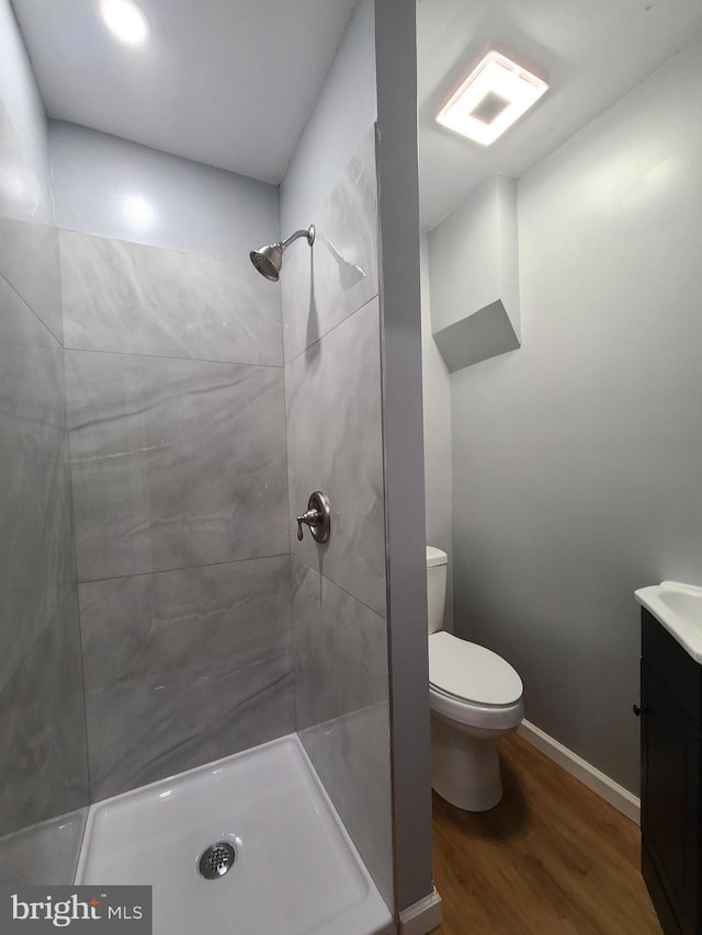 1218 Fidelity St, Reading, PA 19604 - bathroom with toilet, wood finished floors, vanity, and tiled shower