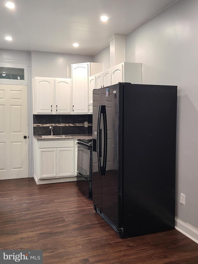 1218 Fidelity St, Reading, PA 19604 - kitchen featuring black appliances, a sink, white cabinets, dark wood-type flooring, and baseboards