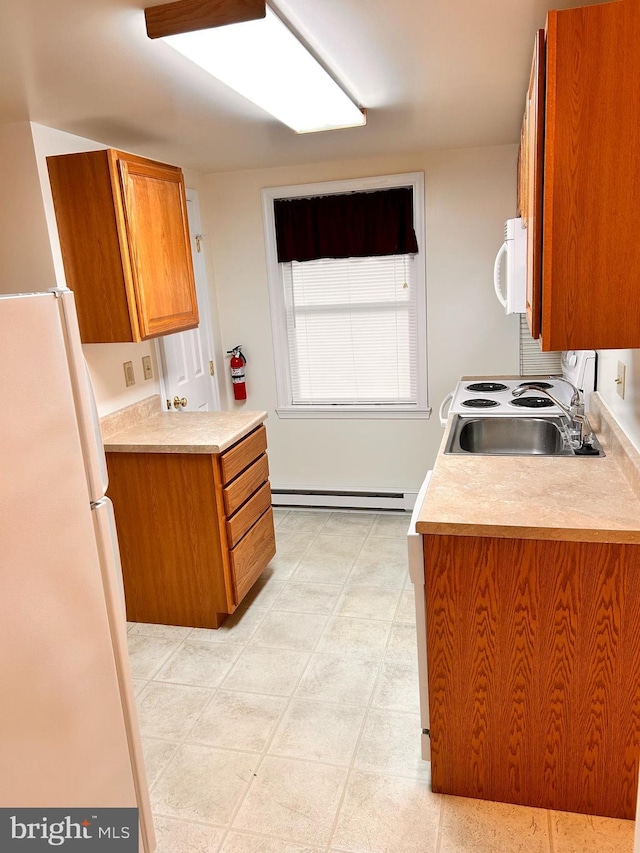 110-112 W Bishop St, Bellefonte, PA 16823 - kitchen featuring white appliances, a baseboard radiator, brown cabinets, a sink, and light countertops