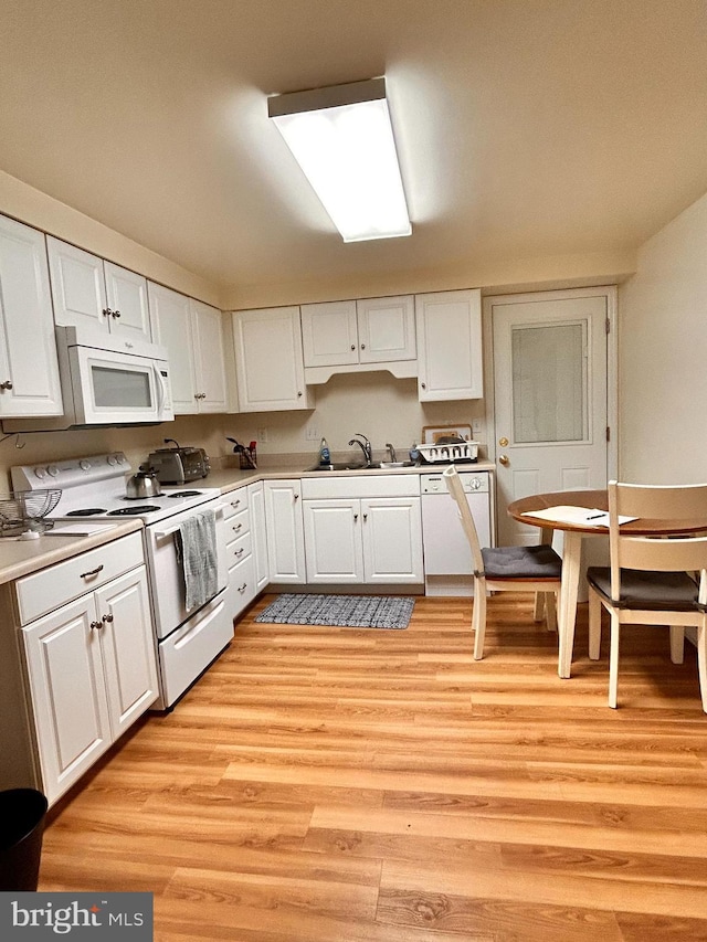 110-112 W Bishop St, Bellefonte, PA 16823 - kitchen featuring white appliances, a sink, white cabinetry, and light wood-style flooring