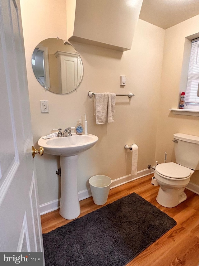 110-112 W Bishop St, Bellefonte, PA 16823 - bathroom with wood finished floors, toilet, and baseboards