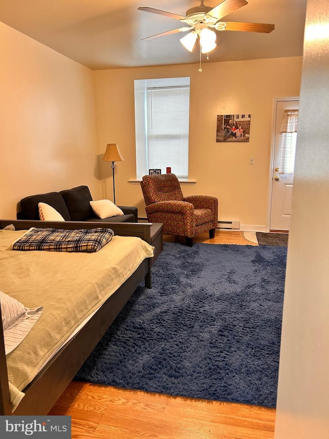 110-112 W Bishop St, Bellefonte, PA 16823 - bedroom with baseboard heating, wood finished floors, and ceiling fan