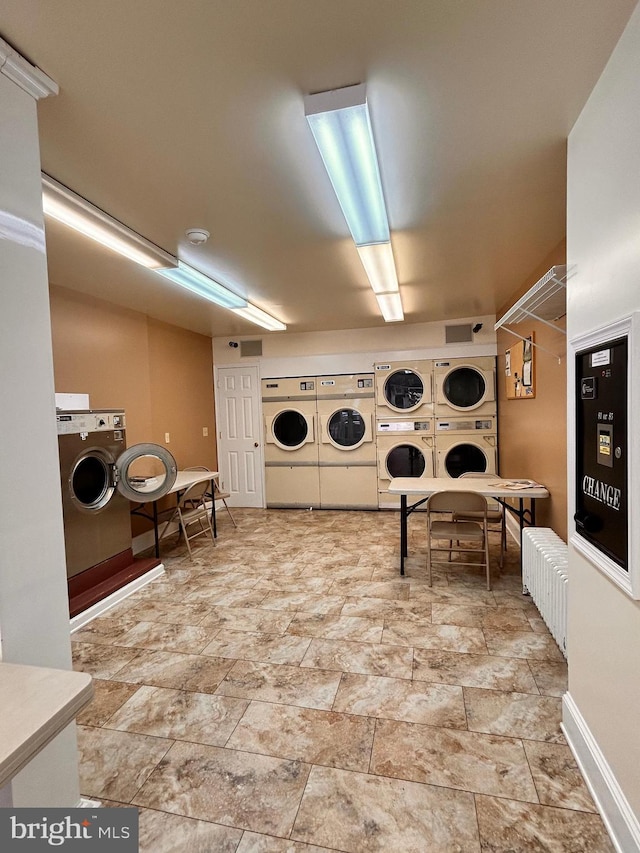 110-112 W Bishop St, Bellefonte, PA 16823 - community laundry room with stacked washer and clothes dryer, separate washer and dryer, stone finish flooring, and baseboards