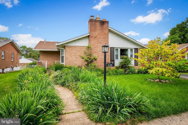 8320 Overmont, Parkville, MD 21234 - view of side of property with a chimney, brick siding, and a yard