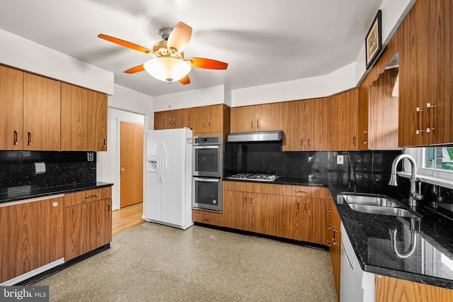8320 Overmont, Parkville, MD 21234 - kitchen with appliances with stainless steel finishes, a sink, under cabinet range hood, ceiling fan, and brown cabinets