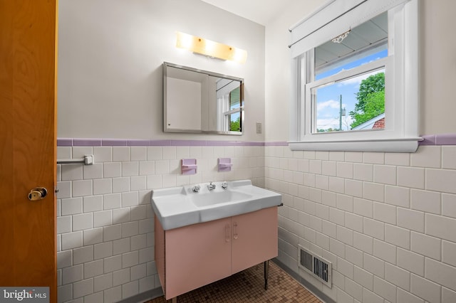 8320 Overmont, Parkville, MD 21234 - bathroom featuring tile walls, wainscoting, vanity, and tile patterned floors