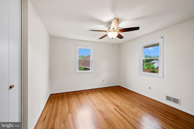 8320 Overmont, Parkville, MD 21234 - empty room featuring healthy amount of natural light, light wood-type flooring, and baseboards