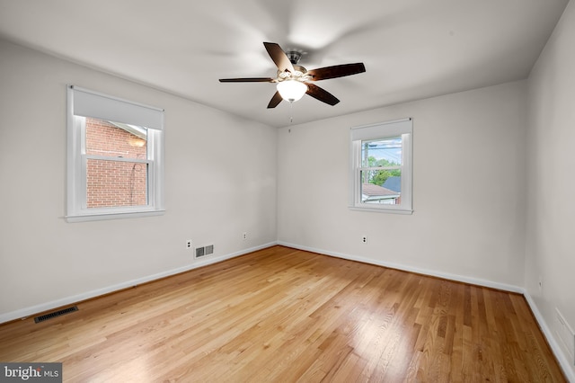 8320 Overmont, Parkville, MD 21234 - spare room featuring wood-type flooring, a ceiling fan, and baseboards
