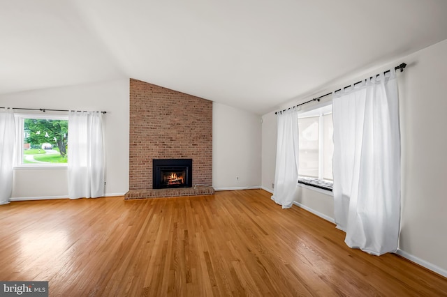 8320 Overmont, Parkville, MD 21234 - unfurnished living room with lofted ceiling, light wood finished floors, baseboards, and a fireplace