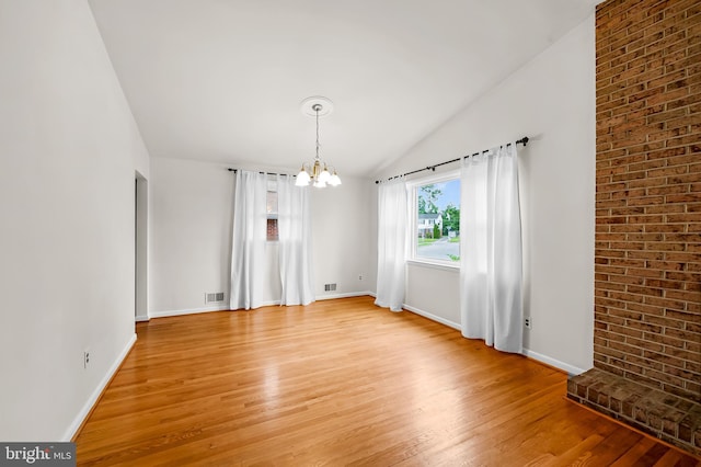 8320 Overmont, Parkville, MD 21234 - spare room with a chandelier, light wood-type flooring, baseboards, and lofted ceiling