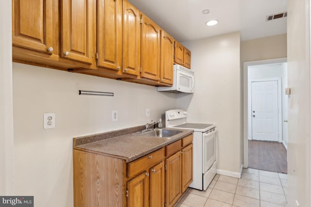 1707 H St NE, Washington, DC 20002 - kitchen featuring white appliances, a sink, light tile patterned floors, brown cabinets, and recessed lighting