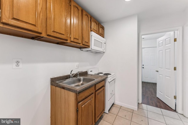 1707 H St NE, Washington, DC 20002 - kitchen featuring white appliances, a sink, light tile patterned floors, and brown cabinets