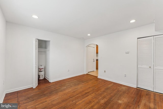 1707 H St NE, Washington, DC 20002 - unfurnished bedroom with arched walkways, wood finished floors, baseboards, and recessed lighting