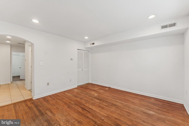 1707 H St NE, Washington, DC 20002 - empty room with arched walkways, baseboards, wood finished floors, and recessed lighting