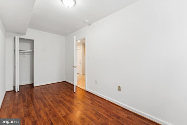 1707 H St NE, Washington, DC 20002 - unfurnished bedroom featuring baseboards, a closet, and wood finished floors