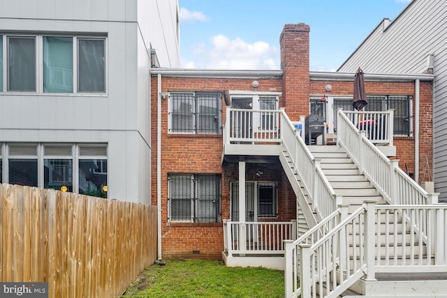 1707 H St NE, Washington, DC 20002 - rear view of property featuring stairway, brick siding, crawl space, and a chimney