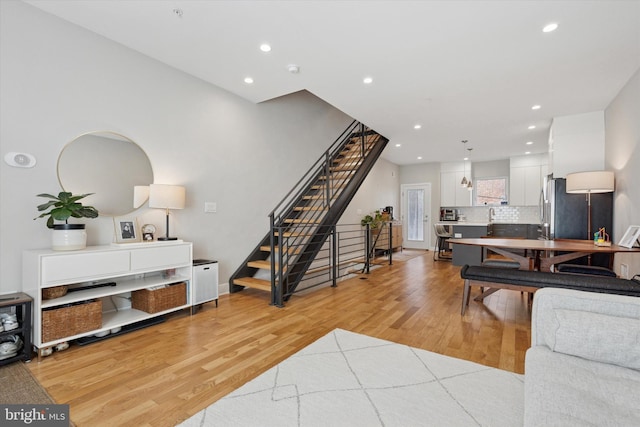2811 Wharton St, Philadelphia, PA 19146 - living room with stairway, light wood-style flooring, recessed lighting, and baseboards