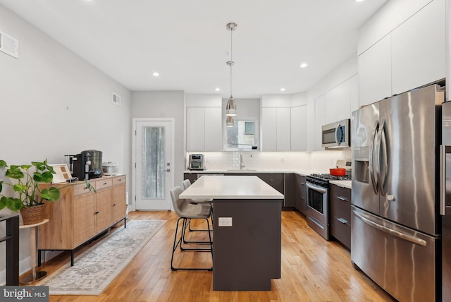 2811 Wharton St, Philadelphia, PA 19146 - kitchen featuring stainless steel appliances, modern cabinets, a sink, a kitchen island, and a kitchen breakfast bar