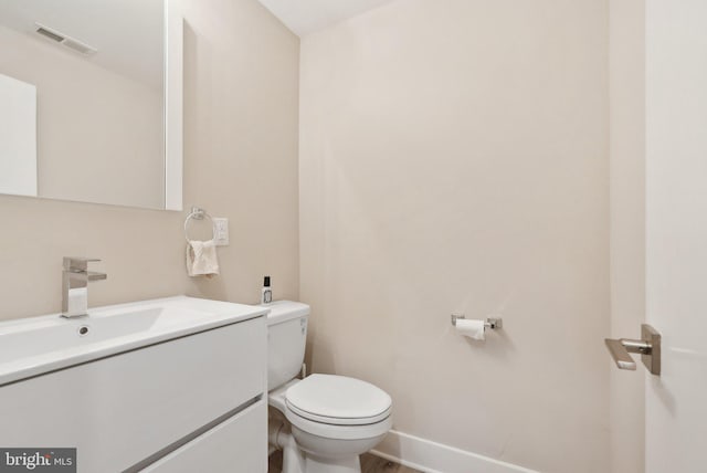 2811 Wharton St, Philadelphia, PA 19146 - half bathroom featuring toilet, vanity, and baseboards