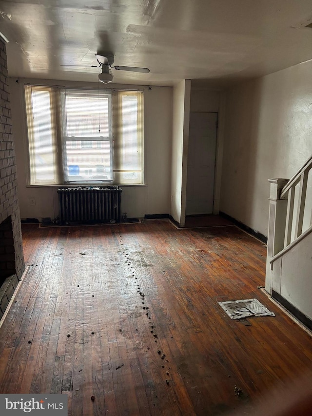 1436 S Etting St, Philadelphia, PA 19146 - unfurnished living room with radiator heating unit, hardwood / wood-style flooring, a ceiling fan, stairs, and baseboards