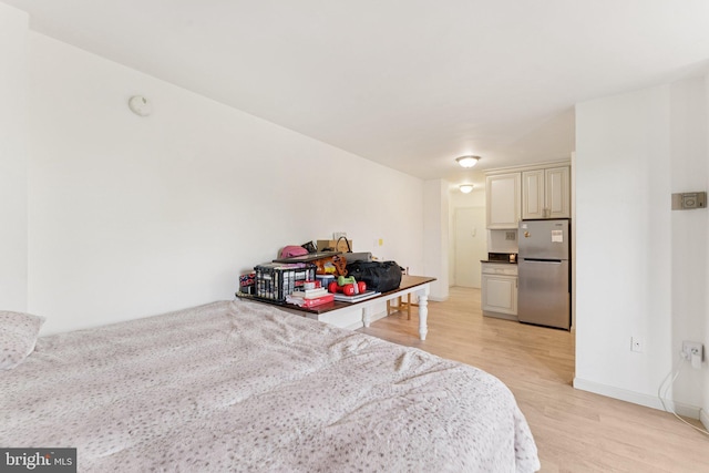 801 N Pitt St Unit 505, Alexandria, VA 22314 - bedroom featuring freestanding refrigerator and light wood-style flooring