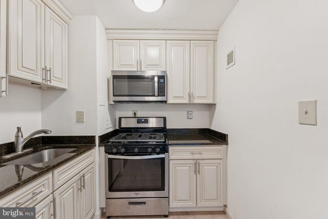 801 N Pitt St Unit 505, Alexandria, VA 22314 - kitchen featuring stainless steel appliances, a sink, and dark stone counters